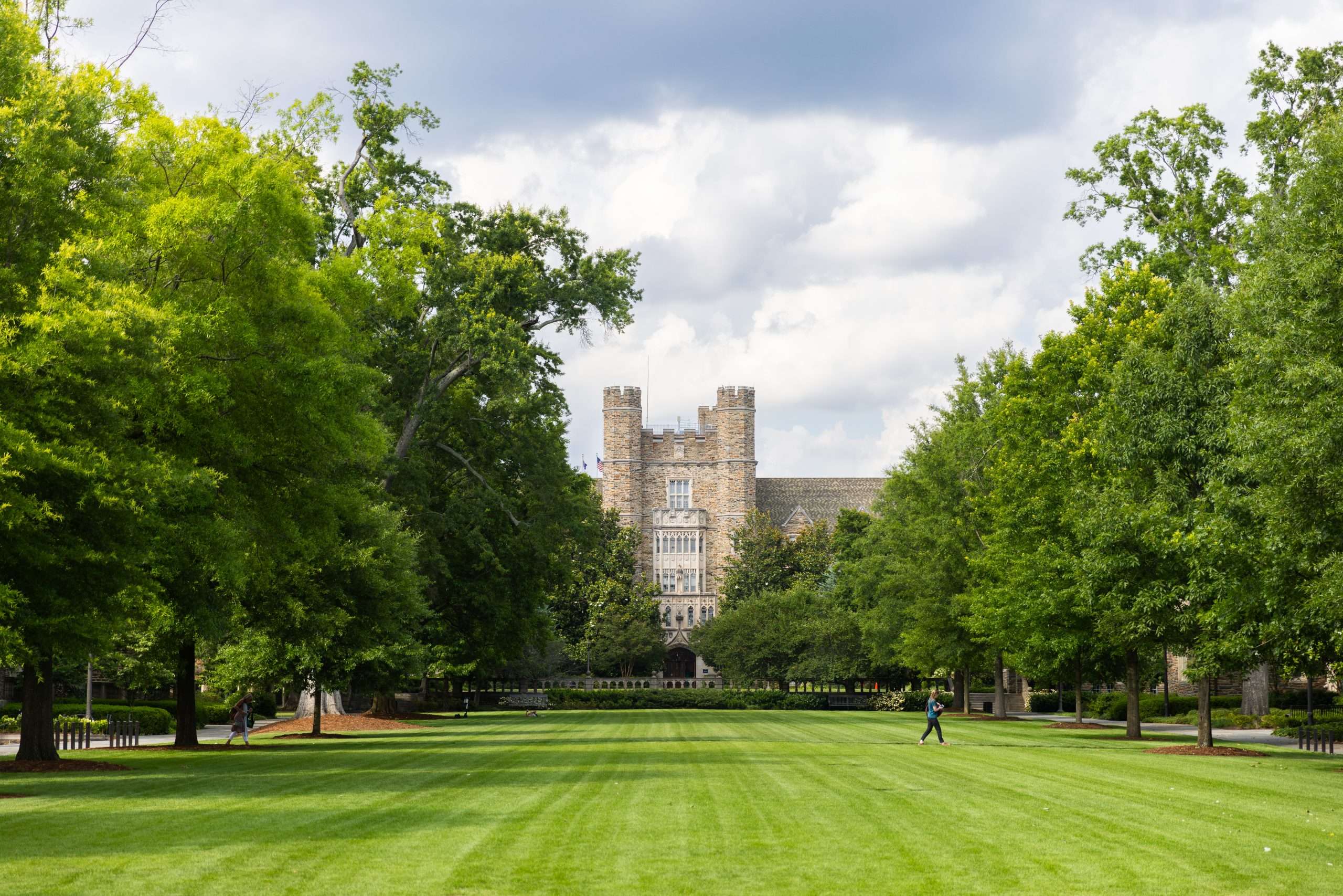 A well manicured lawn is featured in front of a gothic building at Duke University.
